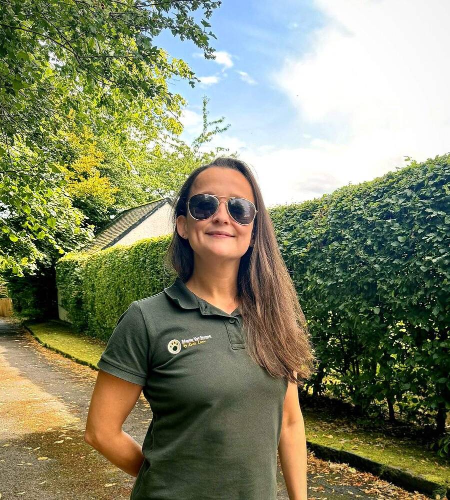 Katie Lunn, registered veterinary nurse, outdoors in her Home Vet Nurse uniform